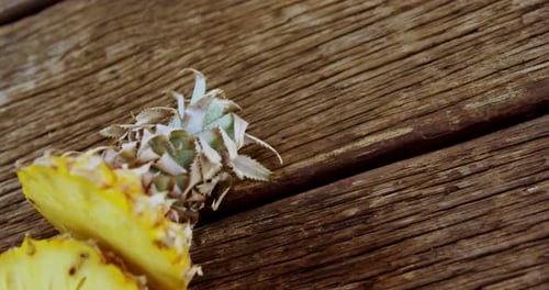 Close Up of Sliced Pineapple on Wood Table