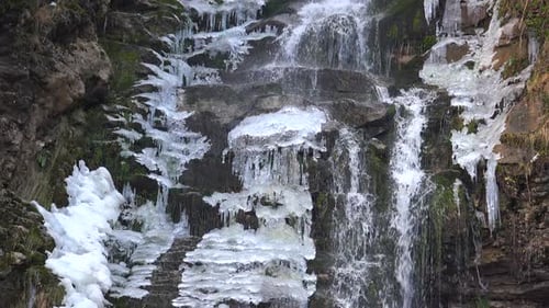 Winter Waterfall with Ice and Snow in Nature