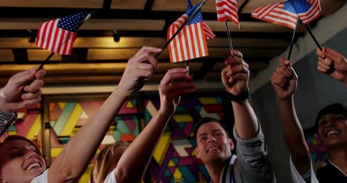 Group of friends waving american flag