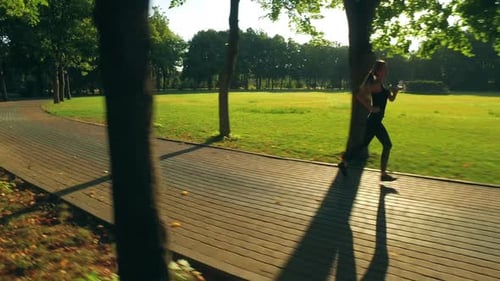 Runner Woman Running in Park Exercising Outdoors