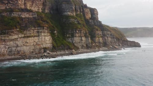 Aerial View of the Picturesque High Coastline Sharp Cliffs and Raging Sea
