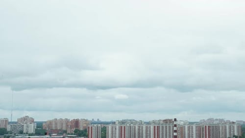 City with Cloud Pass Over Buildings and Skyscrapers. Time Lapse
