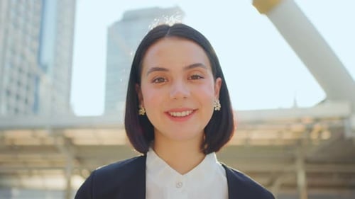 Asian young smart businesswoman standing outdoor with smile face, working in company office in city.