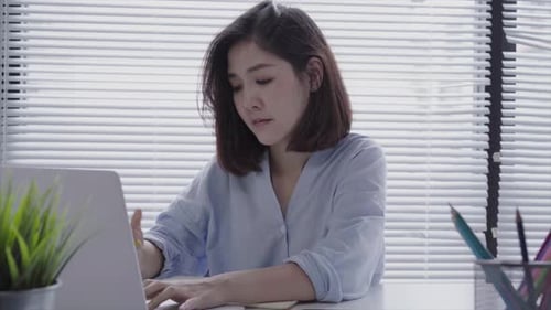 Young Woman Working on Laptop in Office