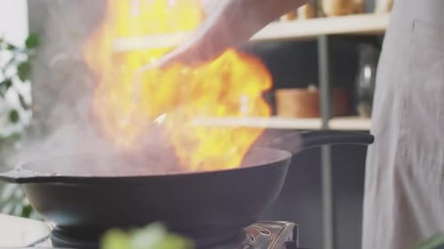 Chef Flambeing Meat in Cognac