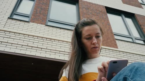Woman Texting on Mobile Phone
