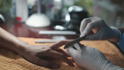 Manicure Master formt Nägel mit Nagelfeile