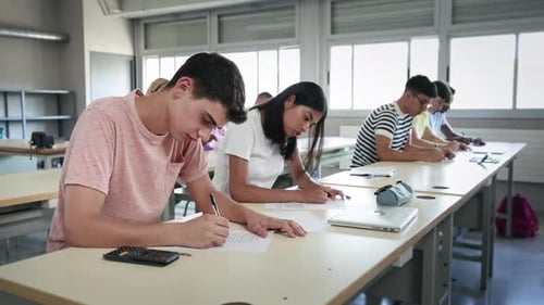 Group of High School Teenager Students Taking Math Exam at Classroom Latin American Girl and