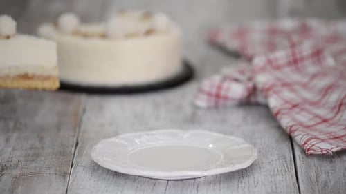 Piece of Layered Cake Being Placed on Plate