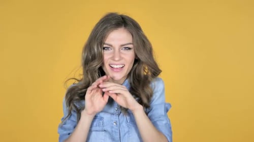 Woman Expressing Emotions with Gestures on Yellow Background