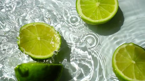 Lime Halves Floating in Water