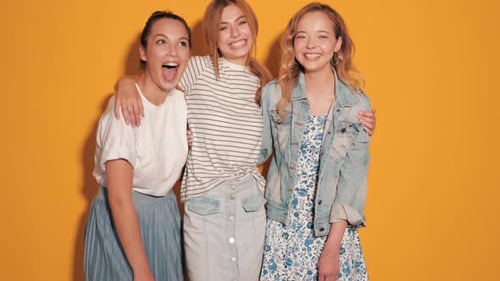 Three Young Women Laughing and Embracing
