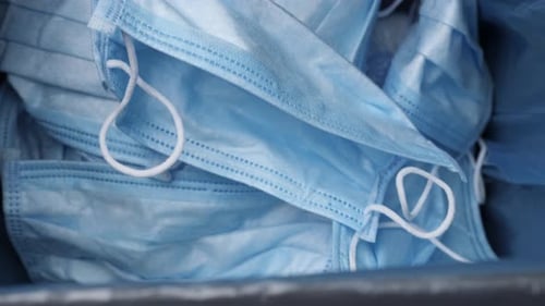 Pile of Light Blue Surgical Masks Close Up