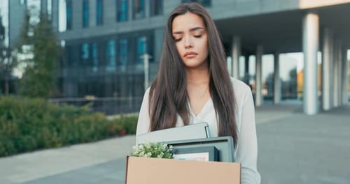 Woman Walks in Front of Glass Modern Office Building of Corporation Where She Worked Being Laid Off