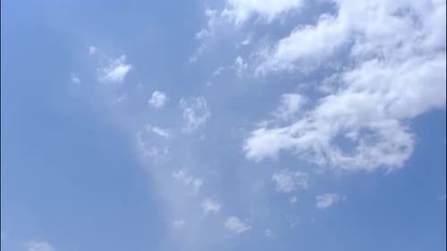 Clouds Drifting in a Vibrant Blue Sky