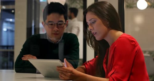 Business colleagues discussing over digital tablet in office 4k