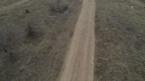 Dirt Road Through Remote Grassy Hills, Aerial Shot