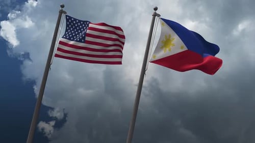 United States and Philippines Flags Waving Against Cloudy Sky
