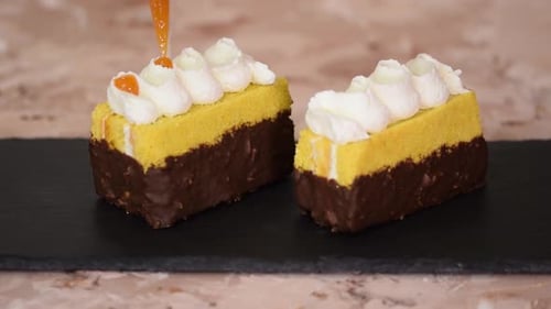 Female Hands Decorate a Sponge Cakes with Apricot Jam From a Pastry Bag