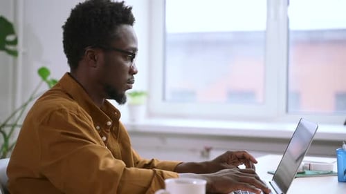 Businessman Working with Laptop and Typing While Sitting at Table in Home Office Spbas