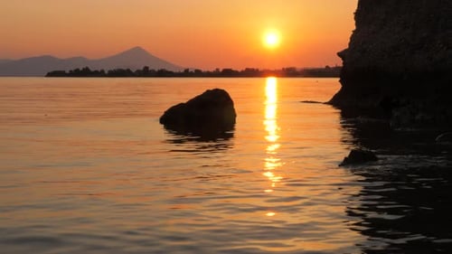 Sunset Seascape with Mountain on Background