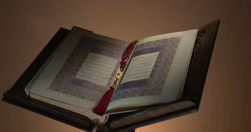 Holy Quran On Book Rest With Prayer Beads