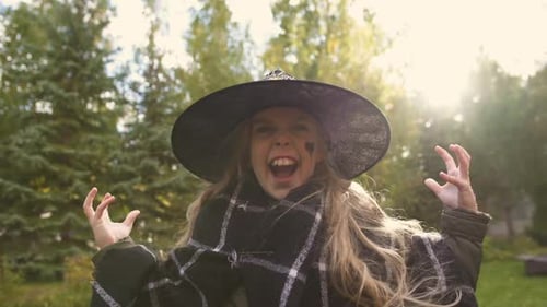 Child in Witch Costume Celebrating Halloween Outdoors