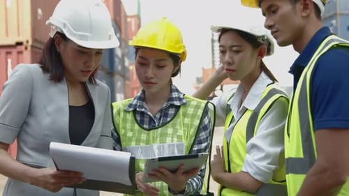 Construction Team Works with Tablet at Shipping Yard