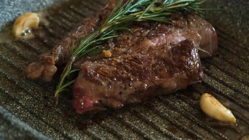 Juicy Steak Sizzling with Rosemary and Garlic
