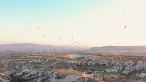 Hot Air Balloons Flying Over Rock Landscape at Cappadocia.