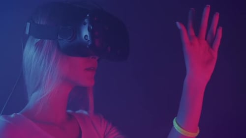 Close Up of Amazed Young Girl Wearing Virtual Reality Glasses Looking at Her Hand, Standing in the
