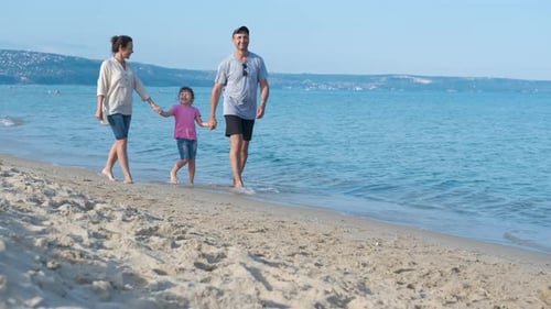 Family walks on the beach.
