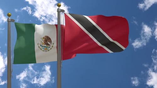 Mexico and Trinidad and Tobago Flags Waving in Blue Sky
