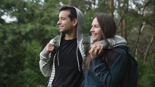 Lovely Couple on the Walk in Forest, Smiling and Looking Into the Distance