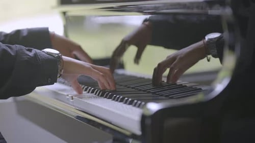 Pianist performs playing a piano. Hands close up