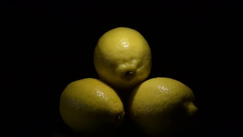Pile of Four Yellow Lemons Rotating