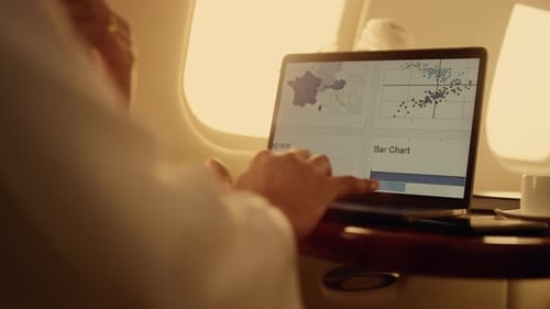 Adult Working on Laptop in Private Jet
