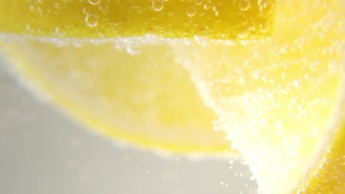 Slices of Lemon Submerged in Bubbling Water