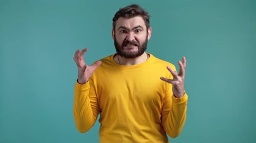 Angry Bearded Man Clenches Fists in Studio