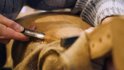 Wooden Workwhop. A Man Carves a Wood. The Carpenter Works in a Studio. An Engineer Provides a Tree