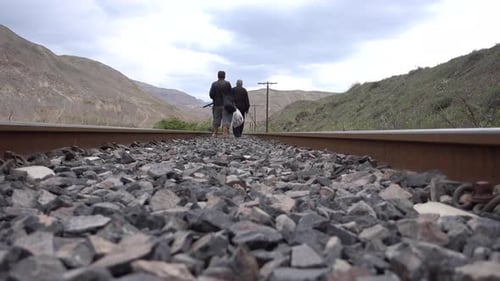 Man Walking On Train Tracks