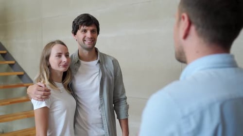 Happy Couple Receiving Apartment Key From Real Estate Agent. Happy Couple Smiling and Getting Keys