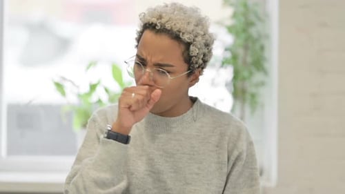 Woman Coughing In Indoor Setting
