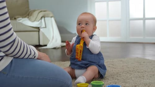 Baby Plays with Toy Giraffe on Rug
