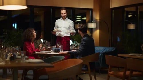 Waiter Serving Hungry Couple in Fancy Restaurant