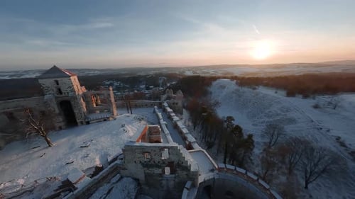 Aerial View of Beautiful Historic Castle Ruins on the Hill in Winter at Sunset