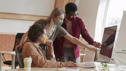 Team Collaborating on Computer in Modern Office