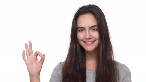 Smiling Woman Makes Okay Hand Gesture