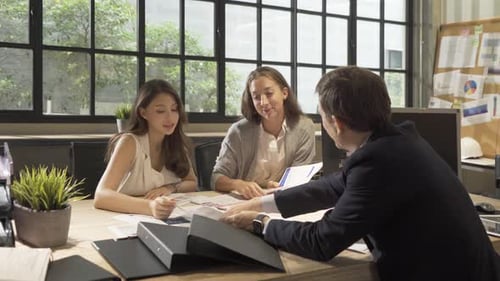 Team Discussing Plans in a Bright Modern Office