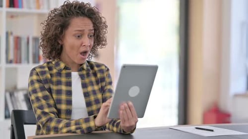 Woman Reacts to Tablet Content in Brightly Lit Room